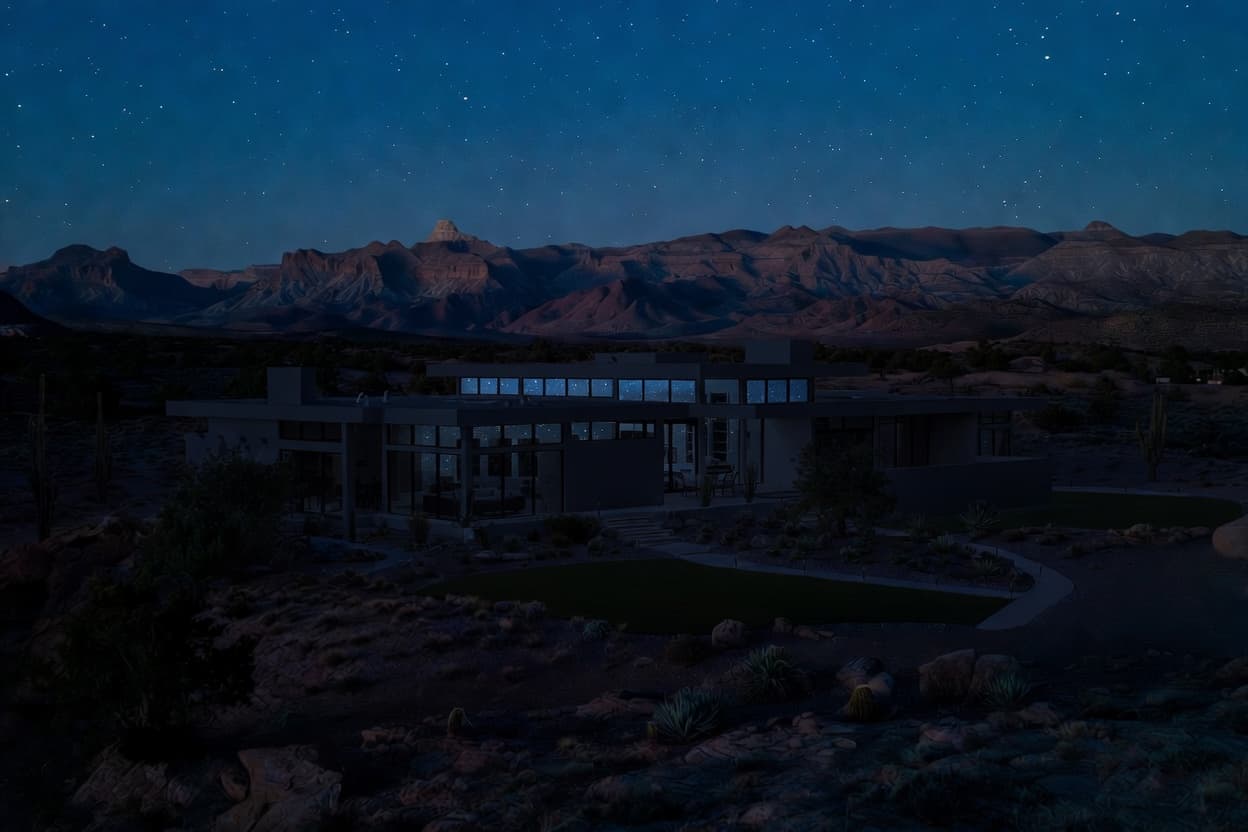 Custom home at night with lights off, set against the Southern Utah desert landscape