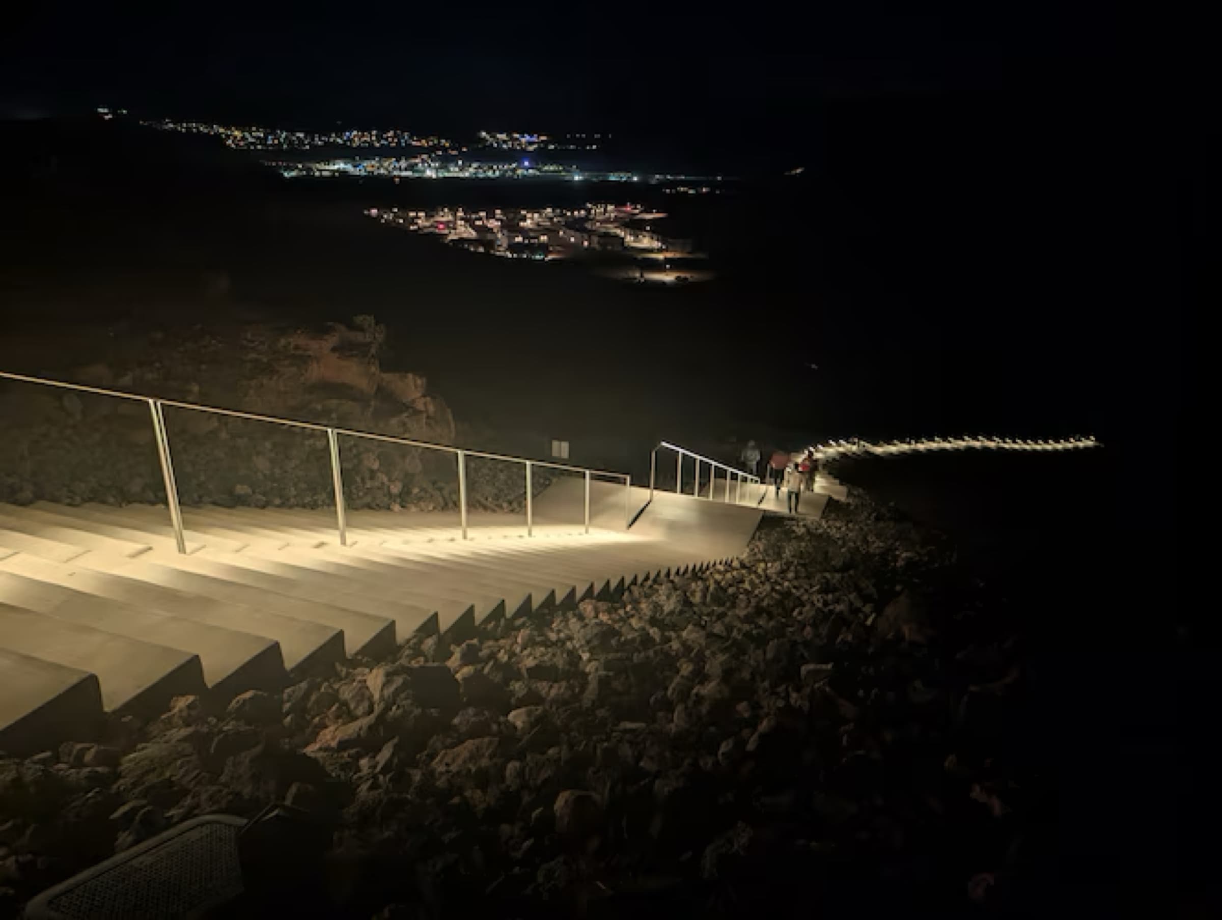 The Tech Ridge Dragon Stairs glowing at night with city lights of St. George in the distance